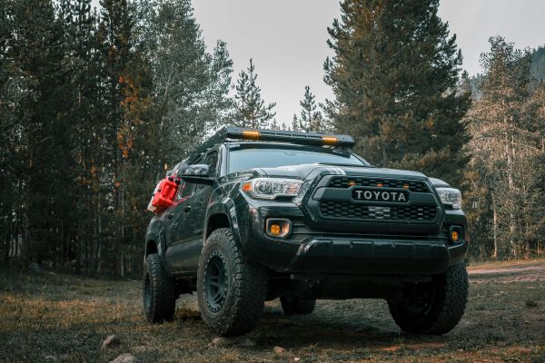Powerful Toyota truck ready for an off-road adventure in a woodland setting.