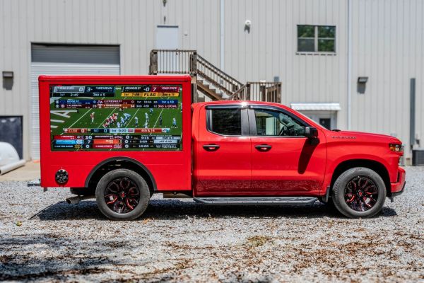 Close-up of a classic vintage yellow car's front grill and headlight showcasing its retro design.